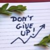 ノートに「Don't give up!」と書かれた画像